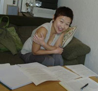 A student takes a break from her studies to smile at the camera.